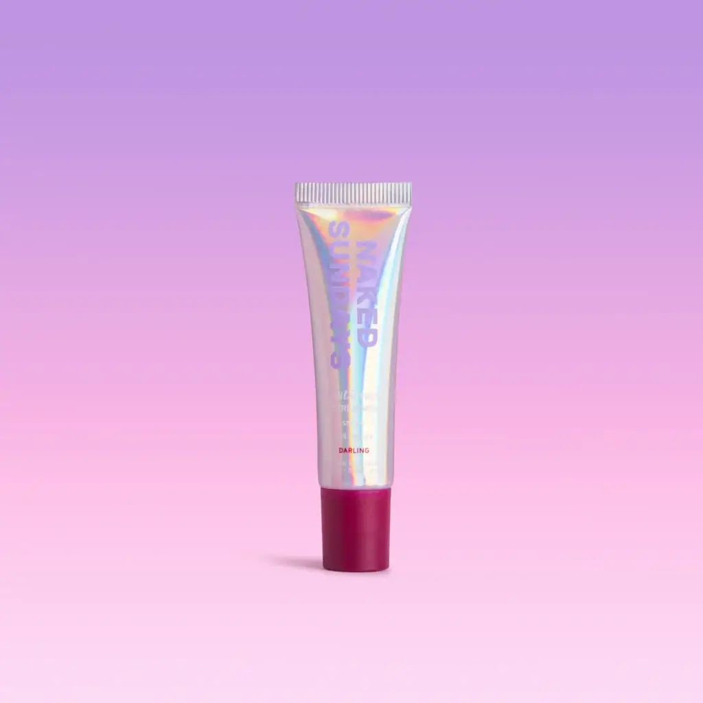 Holographic lipstick tube with a pink cap, centered against a purple-pink gradient background.
