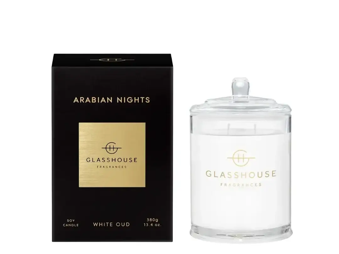 Glasshouse Arabian Nights fragrance set: black box with gold label beside a clear glass candle jar, both displaying the Glasshouse logo (Fragrances).