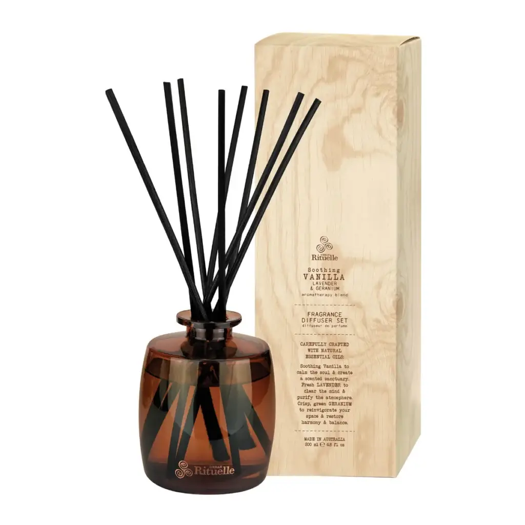 Amber glass diffuser bottle with black reeds beside a wooden fragrance box labeled Rituelle Vanilla & Geranium diffuser set (Soothing vanilla scent)